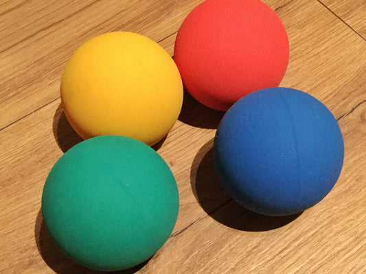 4 Gummibälle in den Farben gelb, grün, blau und rot